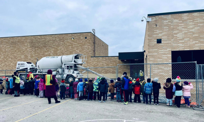 Kids looking at a cement truck outside Ixonia Elementary School