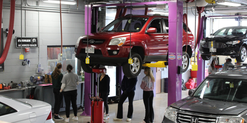 OHS Auto Lab - red car hoisted up for inspection